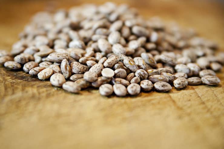 dried pinto beans on a wooden counter