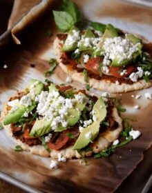Huaraches Topped with Chorizo Refried Beans, Tomatoes and Avocados