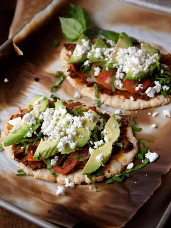 Huaraches Topped with Chorizo Refried Beans, Tomatoes and Avocados