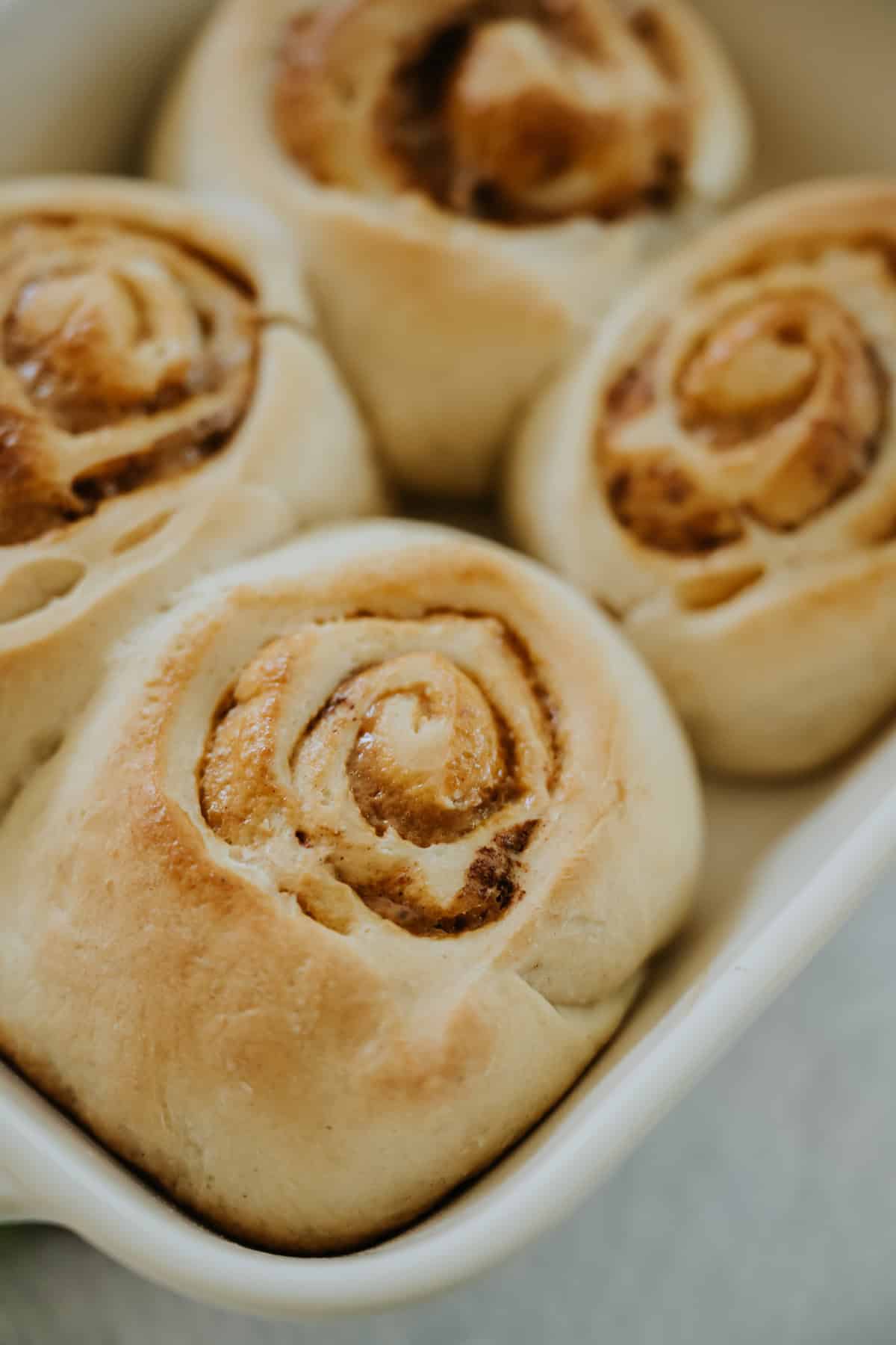 Baked Dulce de Leche and Pecan Cinnamon Rolls in a casserole dish