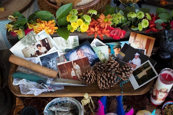 photos on day of the dead altar with personal belongings 