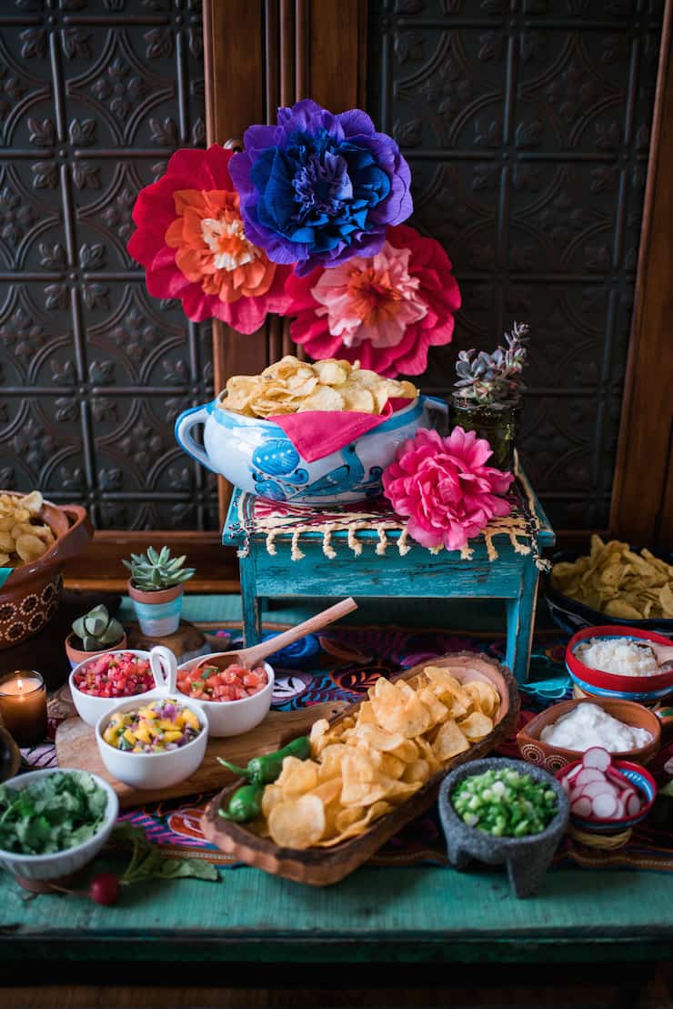 kettle-chip nachos for cinco de mayo nacho bar with colorful paper Mexican flowers