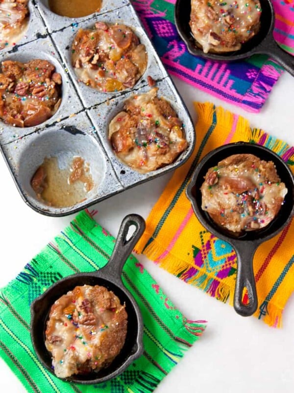 Capirotada Muffins served in cute mini pans on colorful pieces of fabrics