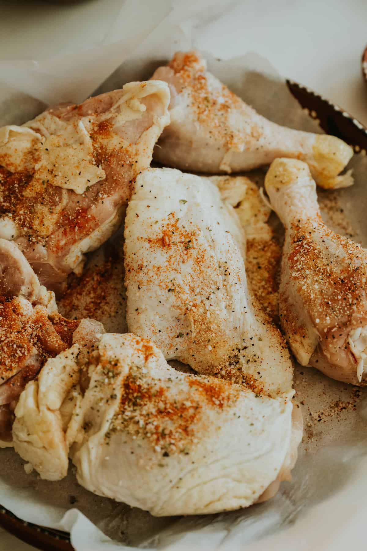 Raw chicken pieces seasoned with spices before cooking Arroz con Pollo.