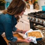 Pulling Thanksgiving Leftover Casserole out of the oven