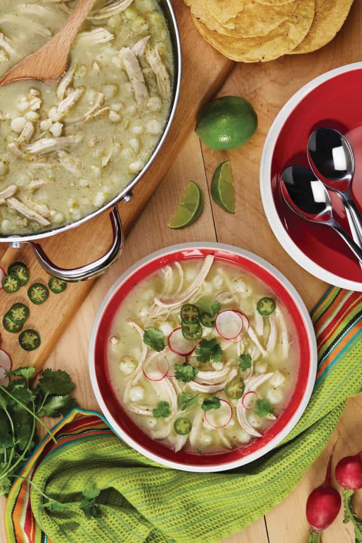 Bowl and pot filled with chicken pozole verde Mexican hominy stew