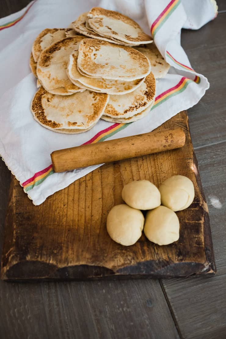 Flour gorditas recipe - some are in balls waiting to be rolled out and cooked, some are completed