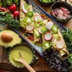 Black Bean, Kale and Bacon Flautas served on an amazing tray with many differnet sides including an avocado