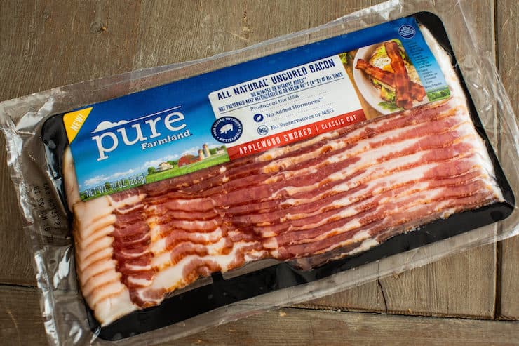 Pure Farmland all natural uncured bacon packed on a big wooden table