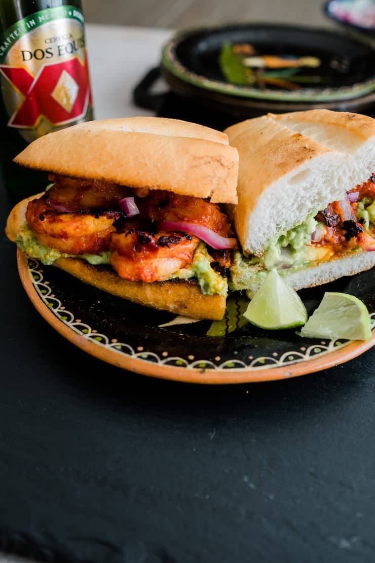 spicy shrimp torta sliced in half on a painted ceramic plate