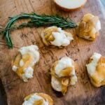 Brie Stuffed with Piloncillo-Caramelized Apples served on a rustic wooden board