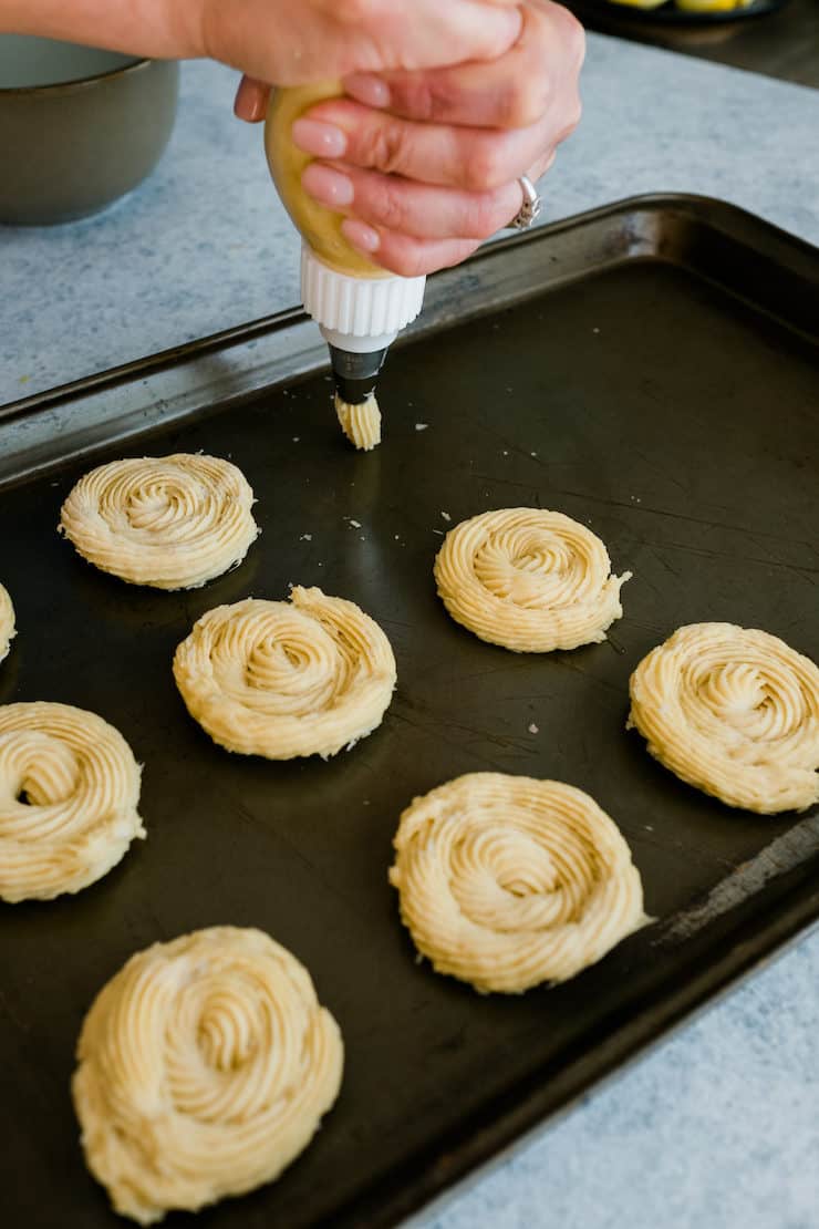 Piping the churros dough on a tray