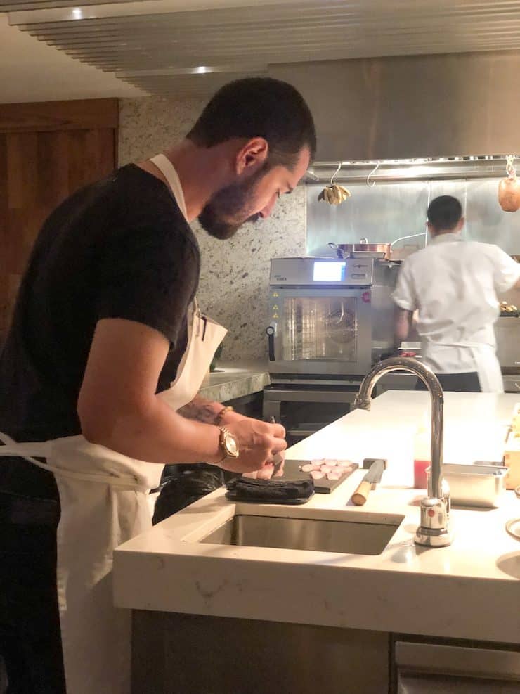 chef preparing 12 course dinner at Emília Restaurant in Mexico City