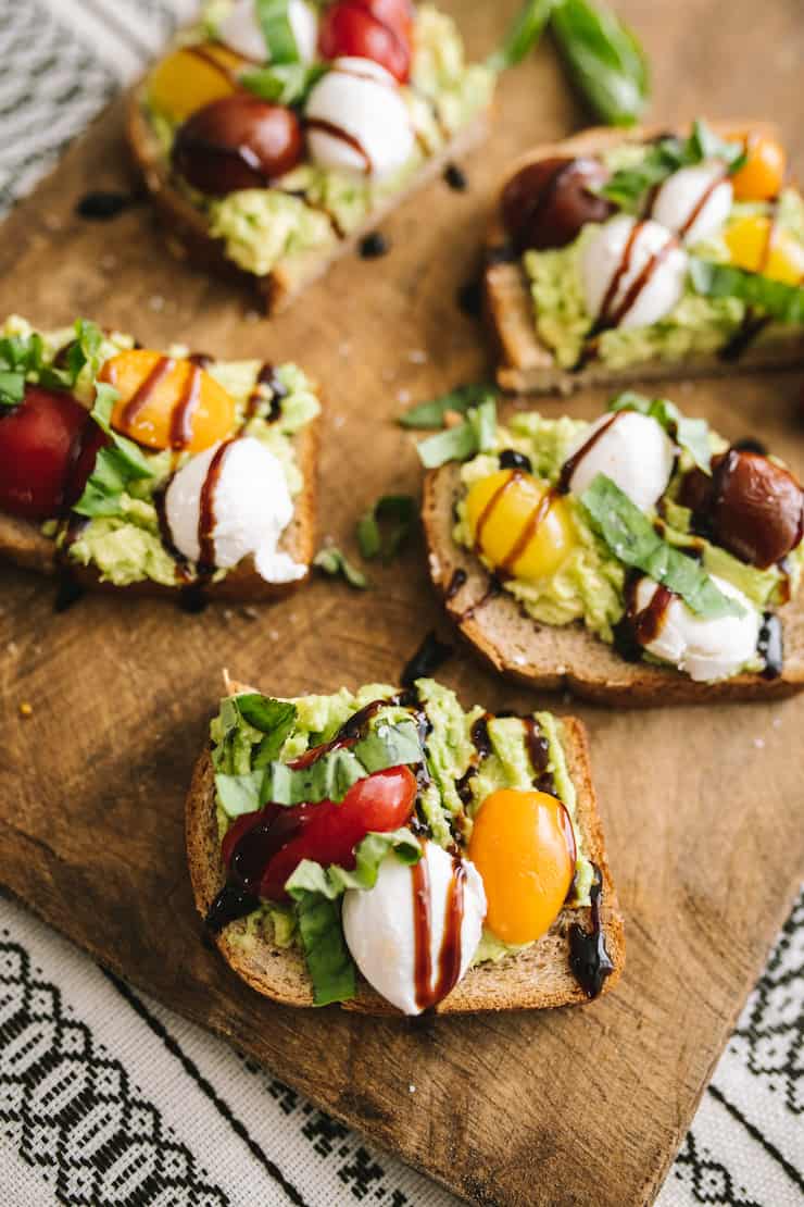 Heart-Healthy Caprese Avocado Toast served on a wooden board