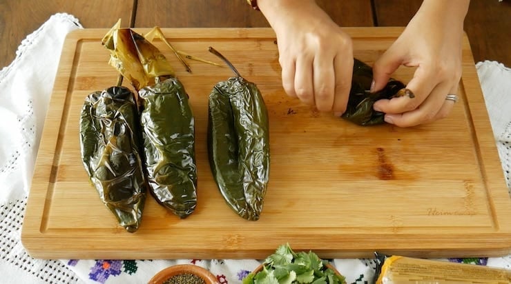 peeling roasted poblanos after steaming.
