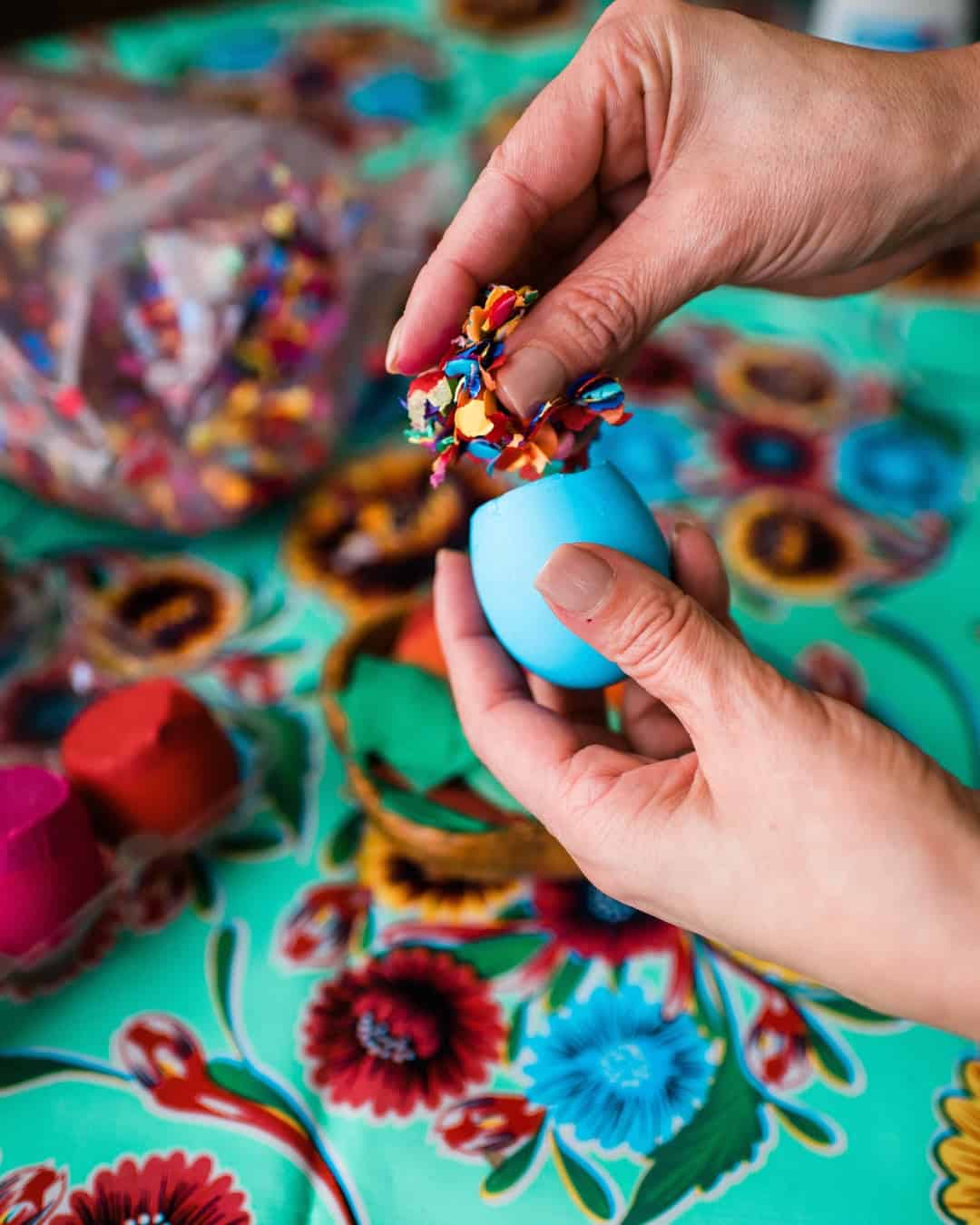 Dyed easter egg shell filled with confetti to make cascarones.