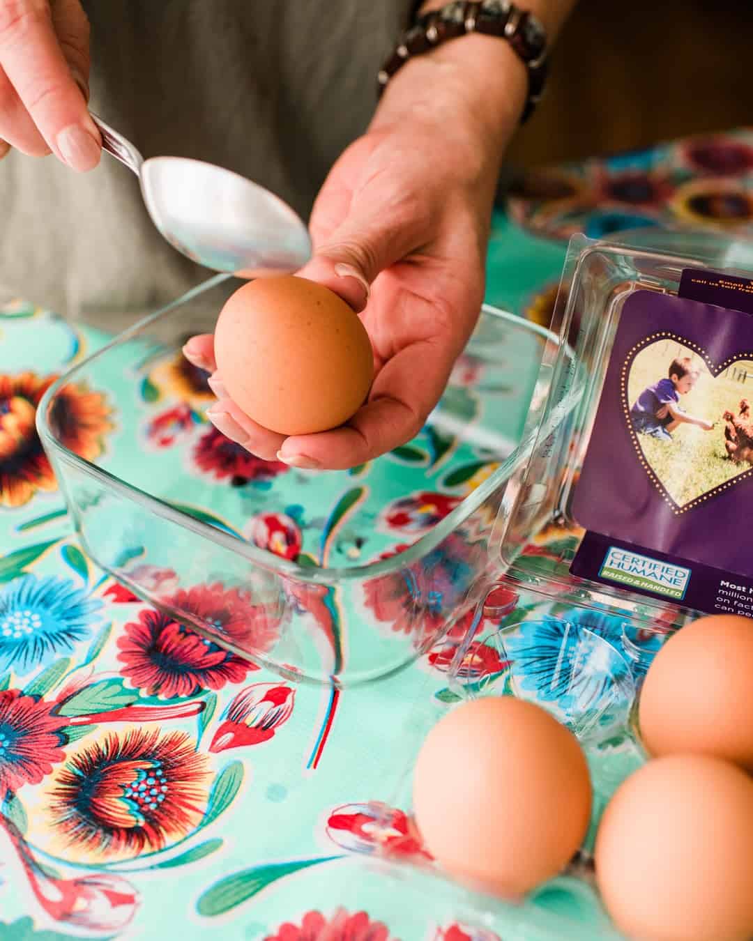 tapping on a brown egg to crack a hole on top to make cascarones.