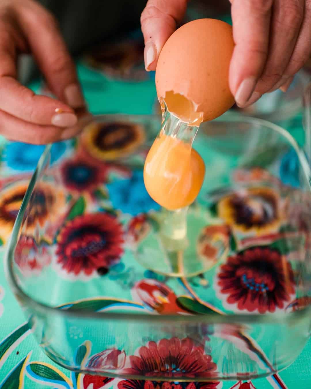 a small hole at the top of an egg and empting out the contents. 