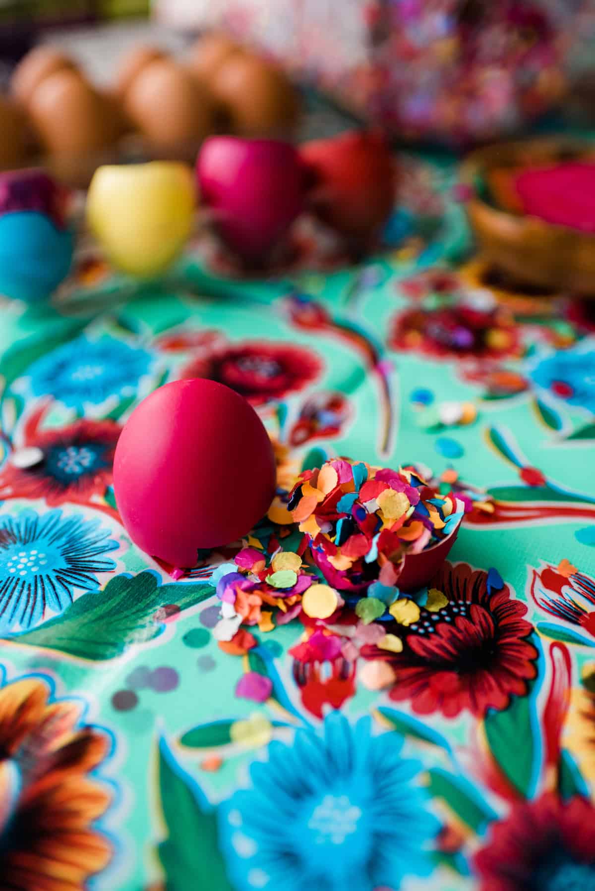 Broken pink easter egg shell filled with confetti.