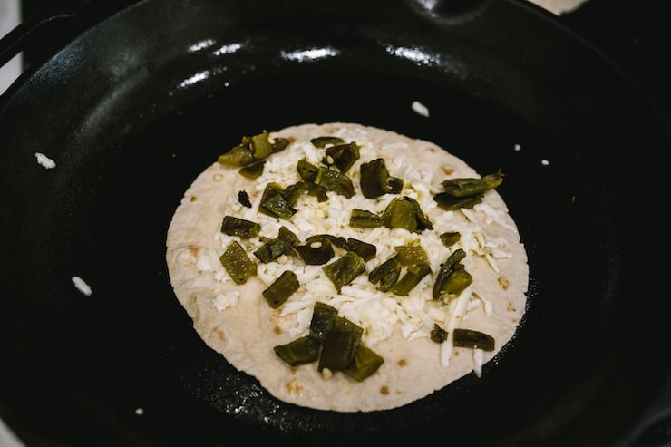 Green Chile and Cheese Quesadilla cooking on cast iron