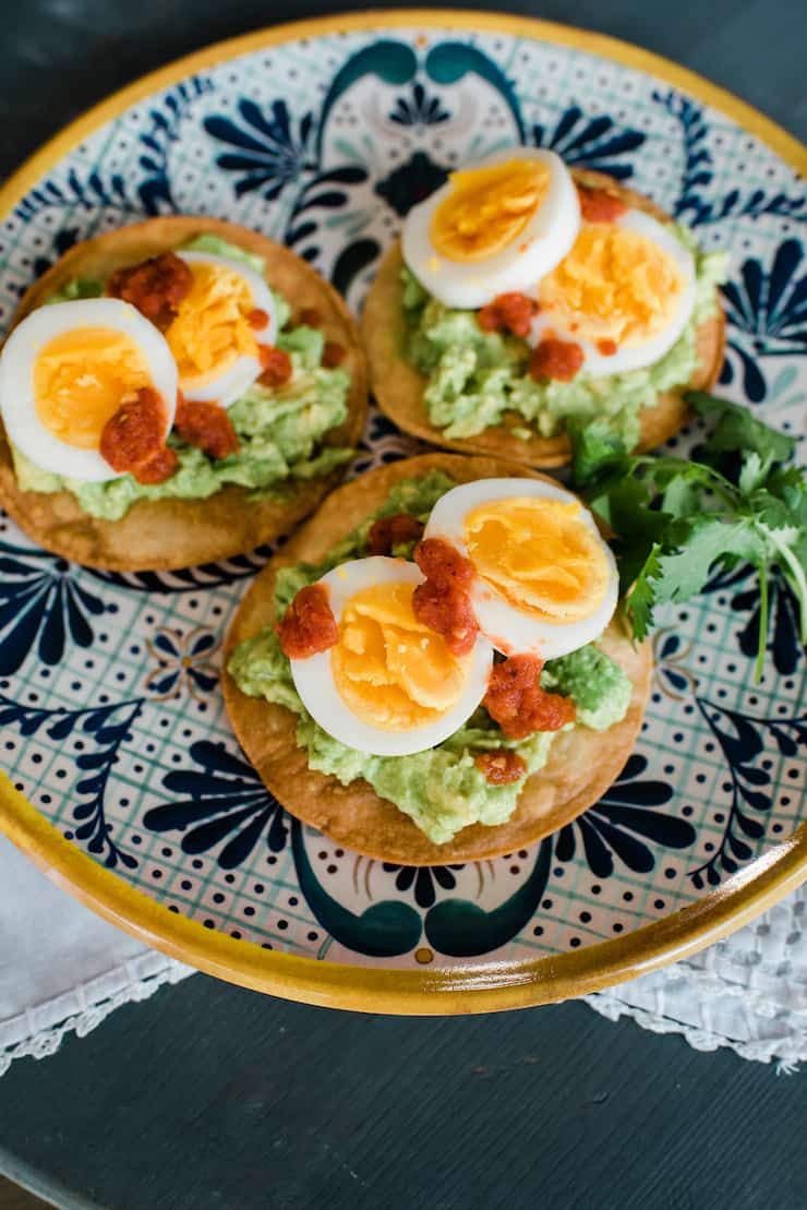 breakfast tostadas with guacamole and hard boil eggs and salsa