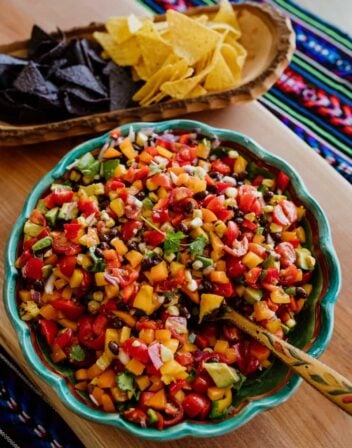 texas Cowboy Caviar in a bowl with chips on the side in a wooden bowl
