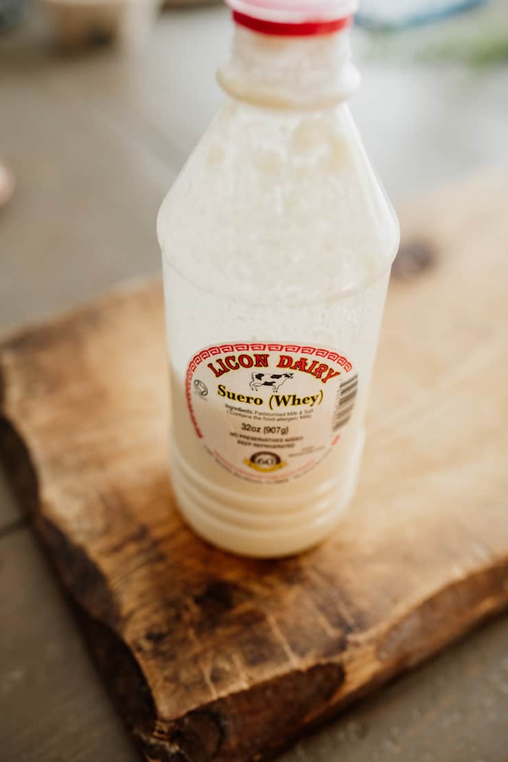 plastic bottle of suero (whey) from Licon Dairy on a wooden board