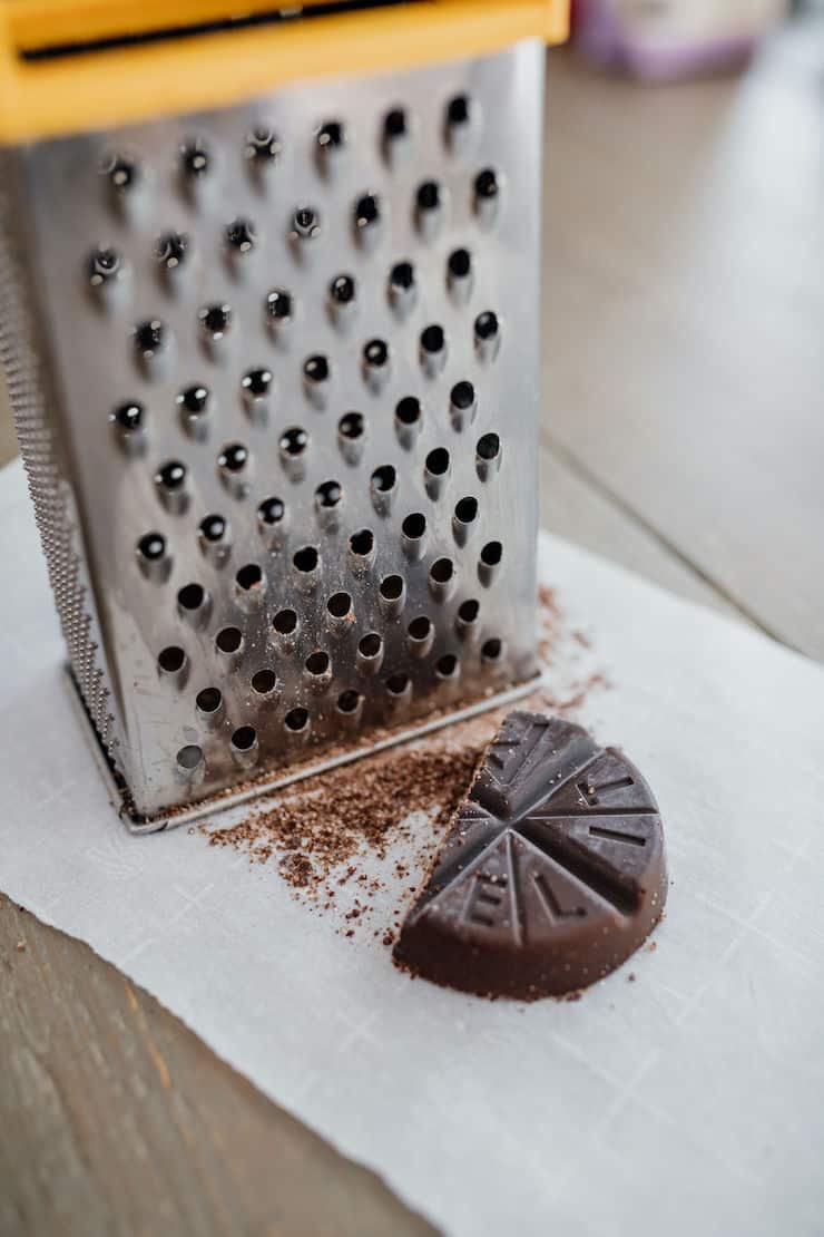 using a box grater to shred Mexican Abuelita chocolate 