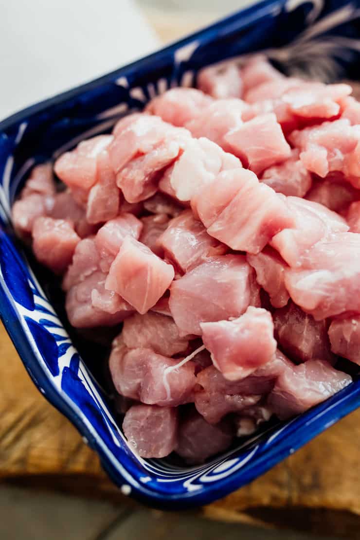 raw pork cubes in a rectangular blue and white dish. 