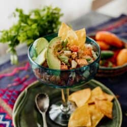 canned salmon salad ceviche style served in a glass with avocado slices and tortilla chips