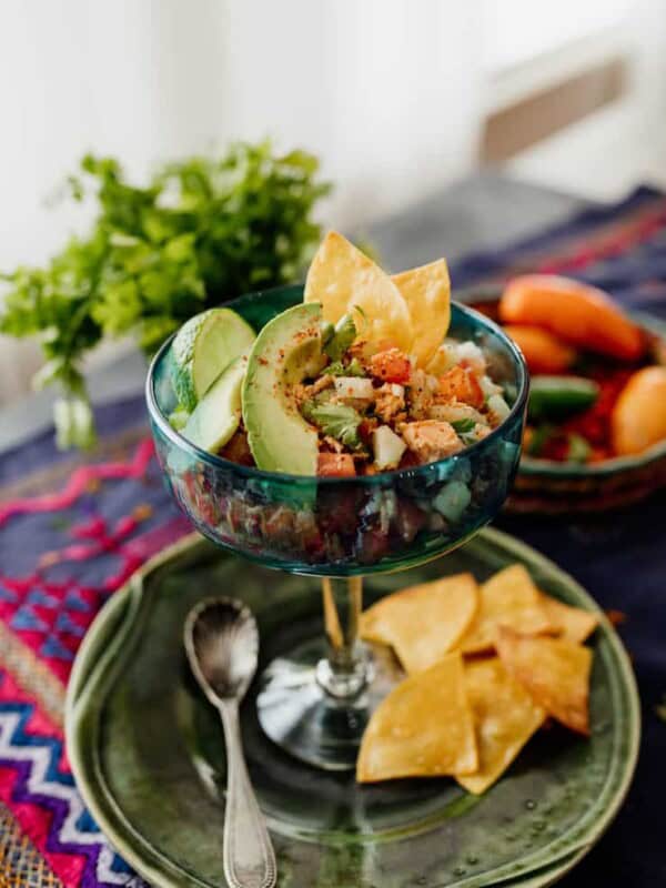 canned salmon salad ceviche style served in a glass with avocado slices and tortilla chips