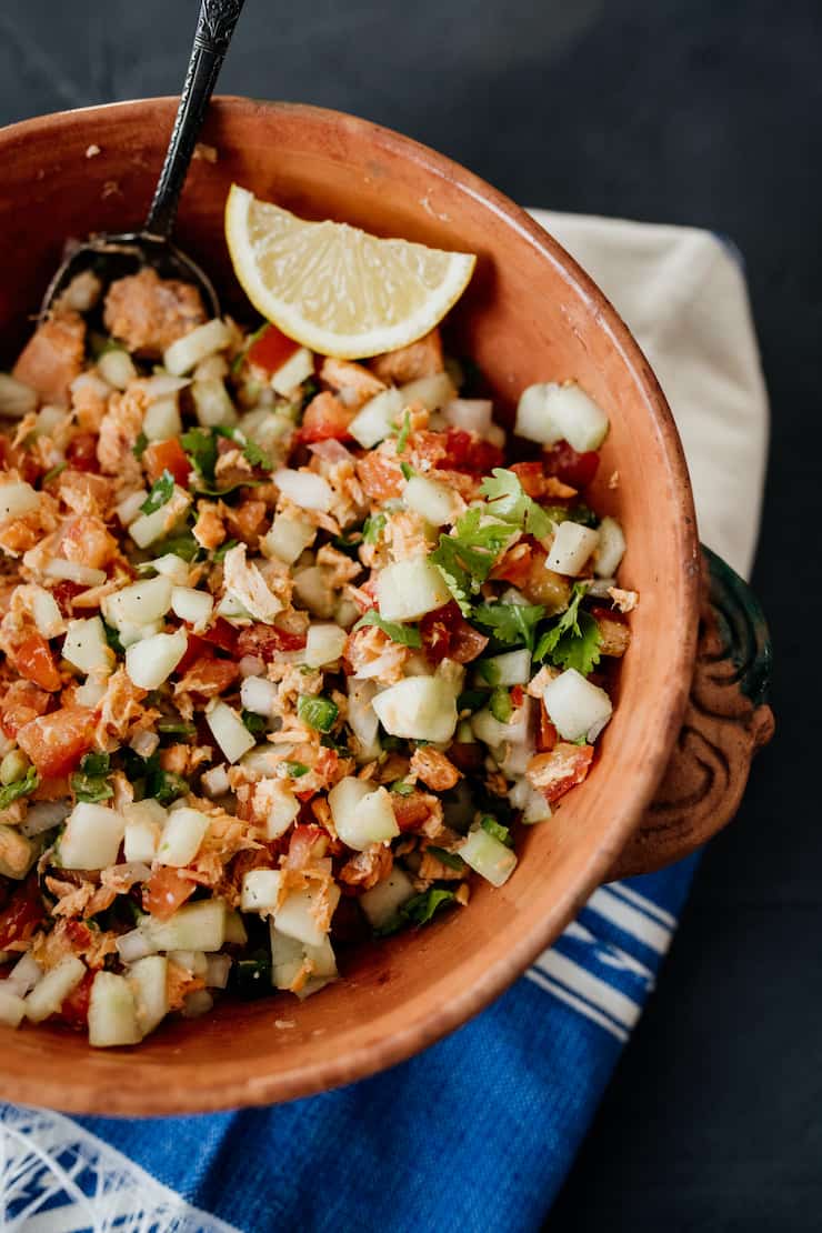 ceviche style canned salmon salad in a terracotta bowl