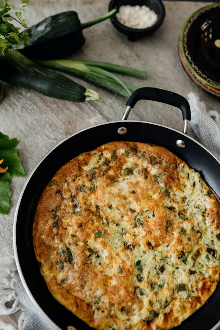 poblano and zucchini vegetable frittata in pan