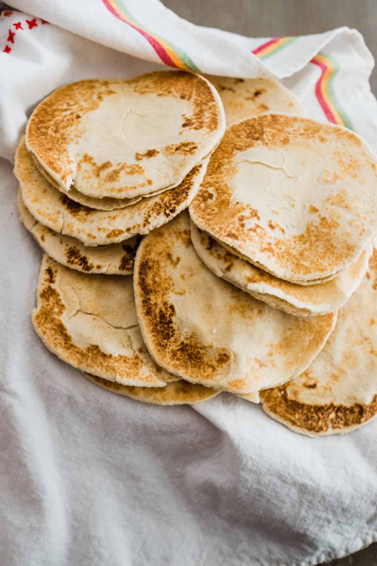 Flour Gorditas (gorditas de harina) on a striped tea towel.