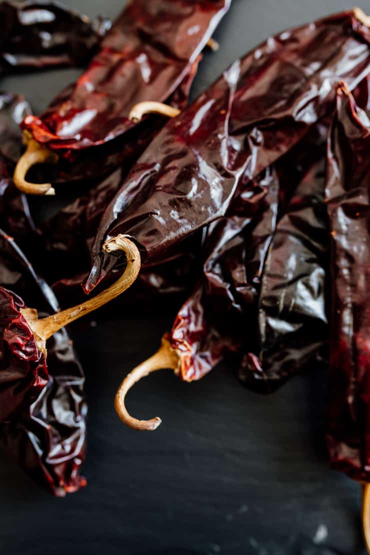 dried New Mexico Chile pods on a black background 
