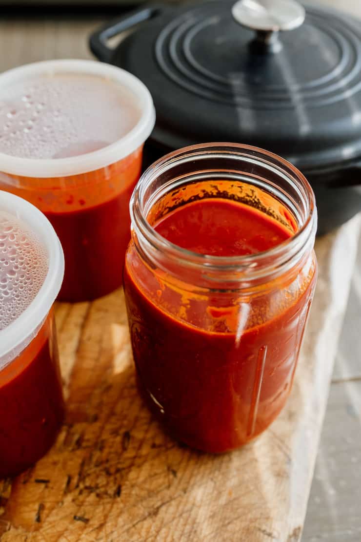 spicy red marinade for making shrimp tortas distributed among a large mason jar and two delitainers