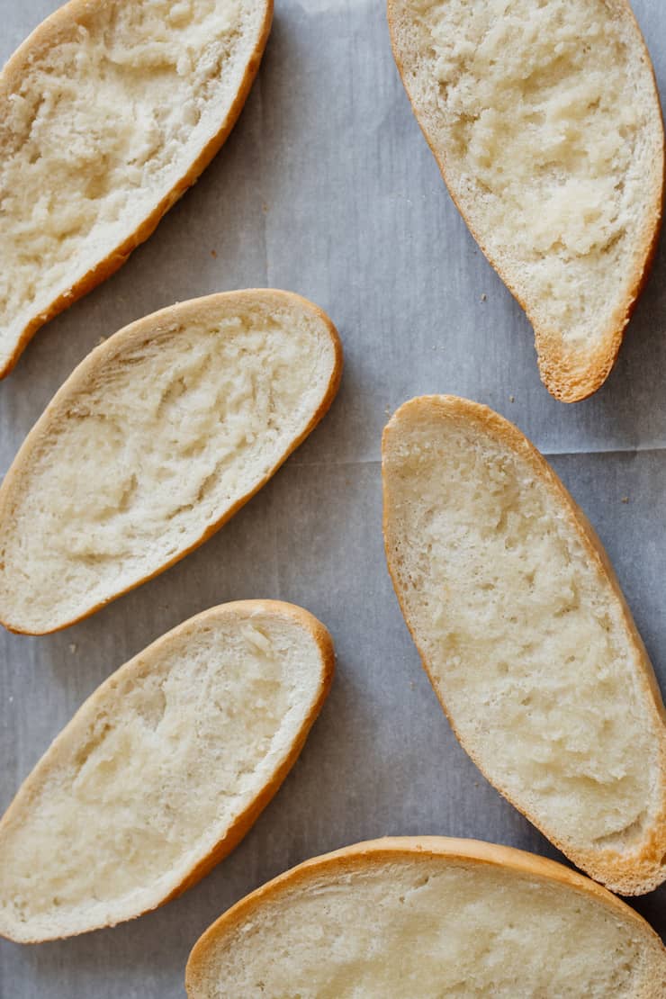 3 bolillos cut in half on a parchment lined baking sheet