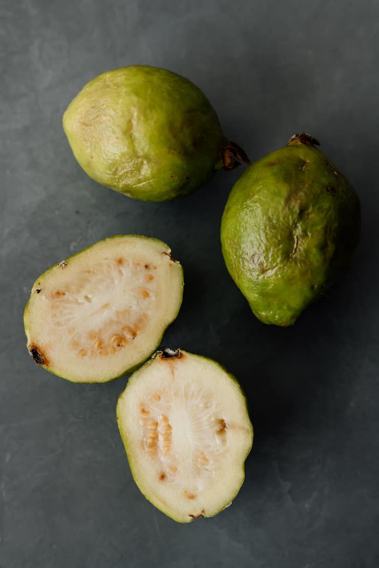 green guavas on a grey background