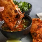 Crispy birria tacos dipped in rich birria consommé with cilantro, onion, and lime, from the authentic Birria de Res recipe by Yvette Marquez of Muy Bueno.