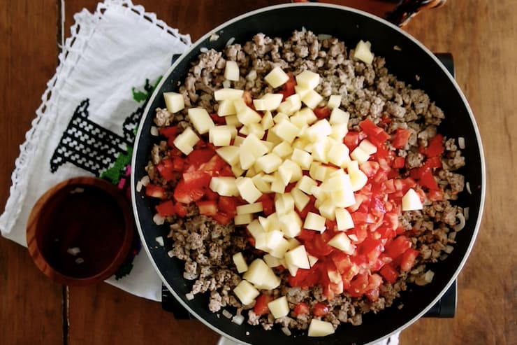 tomatoes and potatoes added to ground meat