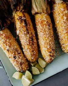 4 pieces of Mexican street corn on a serving platter