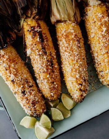 4 pieces of Mexican street corn on a serving platter