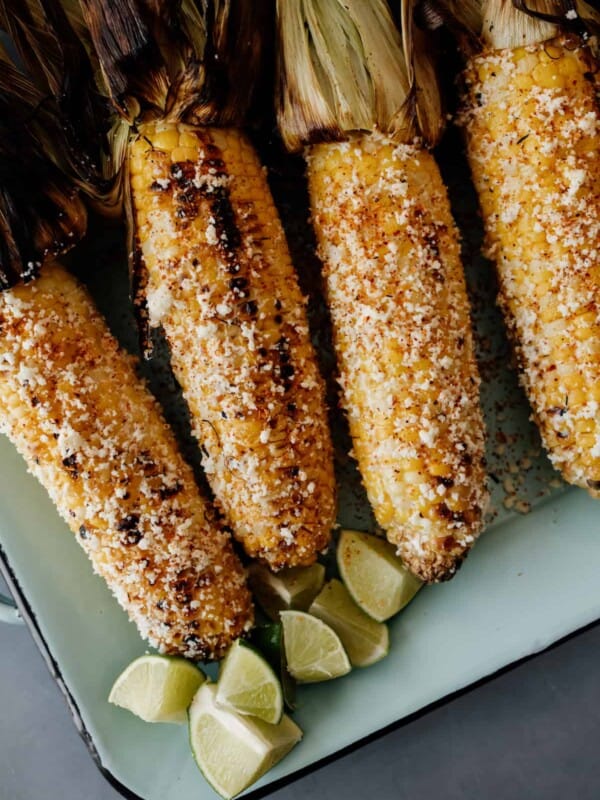 4 pieces of Mexican street corn on a serving platter