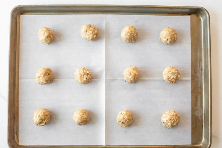 oatmeal cookie dough balls on a cookie sheet