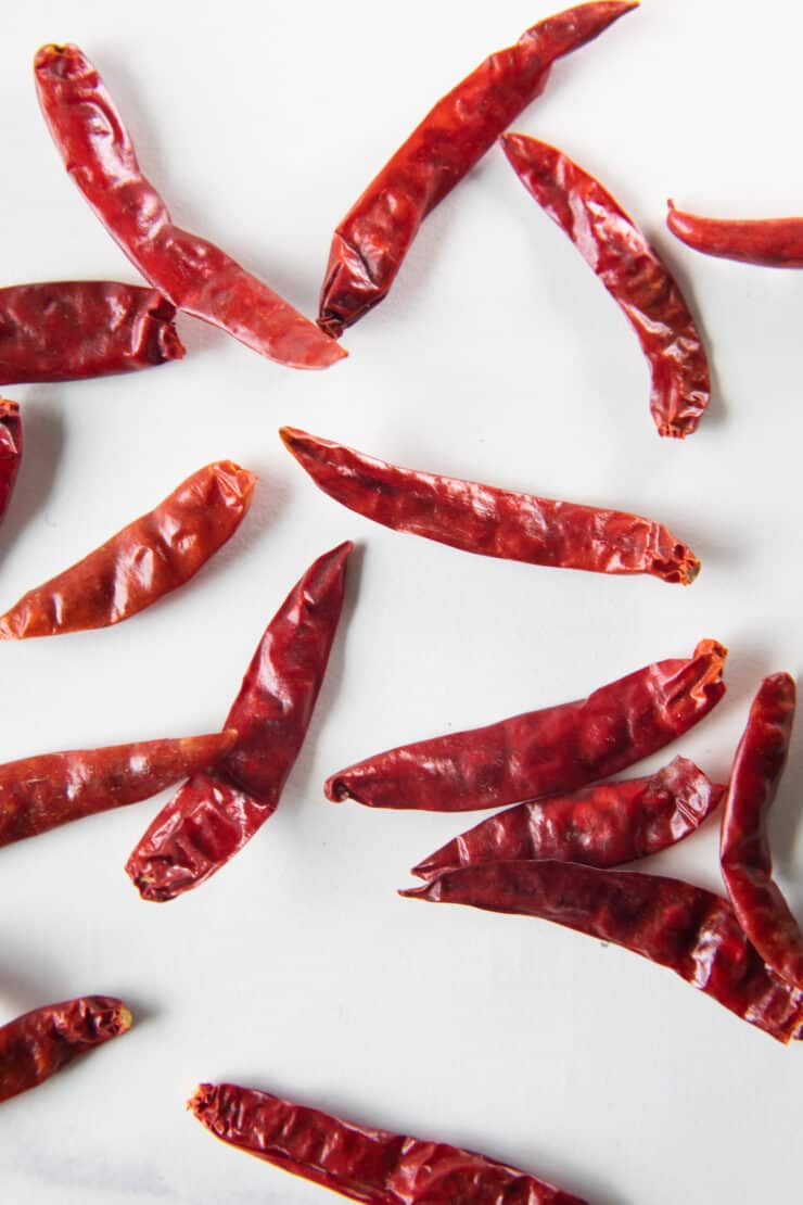 chiles de arbol on a white surface