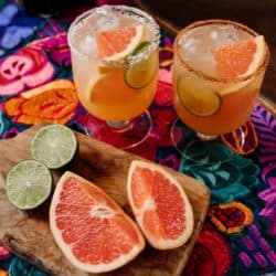 Reposado Paloma recipe made with fresh grapefruit juice, lime juice, reposado tequila, and Tajín-rimmed glasses, styled and prepared by Mexican cookbook author Yvette Marquez-Sharpnack of Muy Bueno.