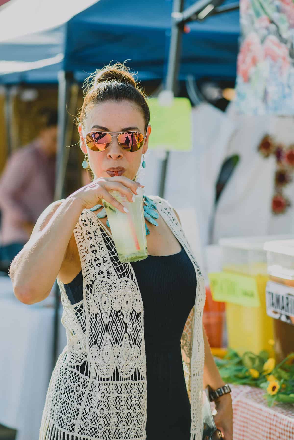 yvette marquez food blogger drinking a cup of agua fresca de pepino in El Paso, Texas.