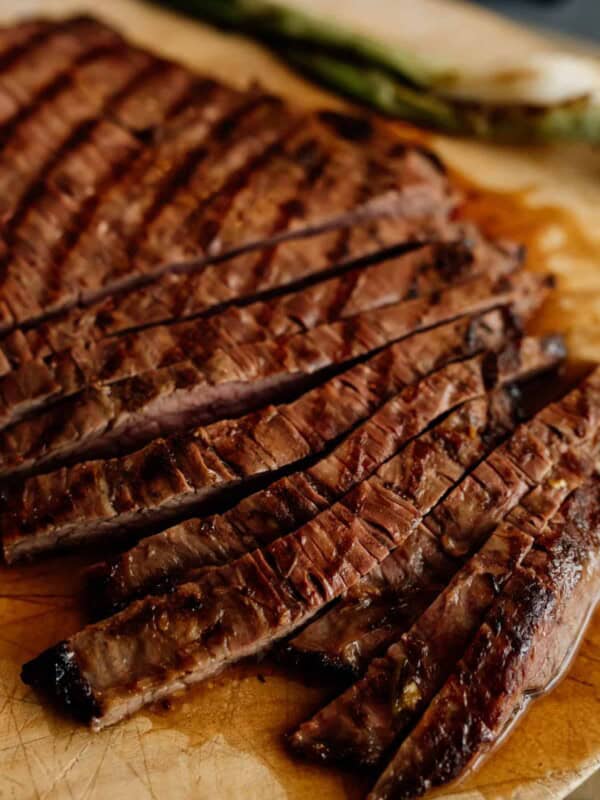 close up shot of sliced carne asada on a cutting board