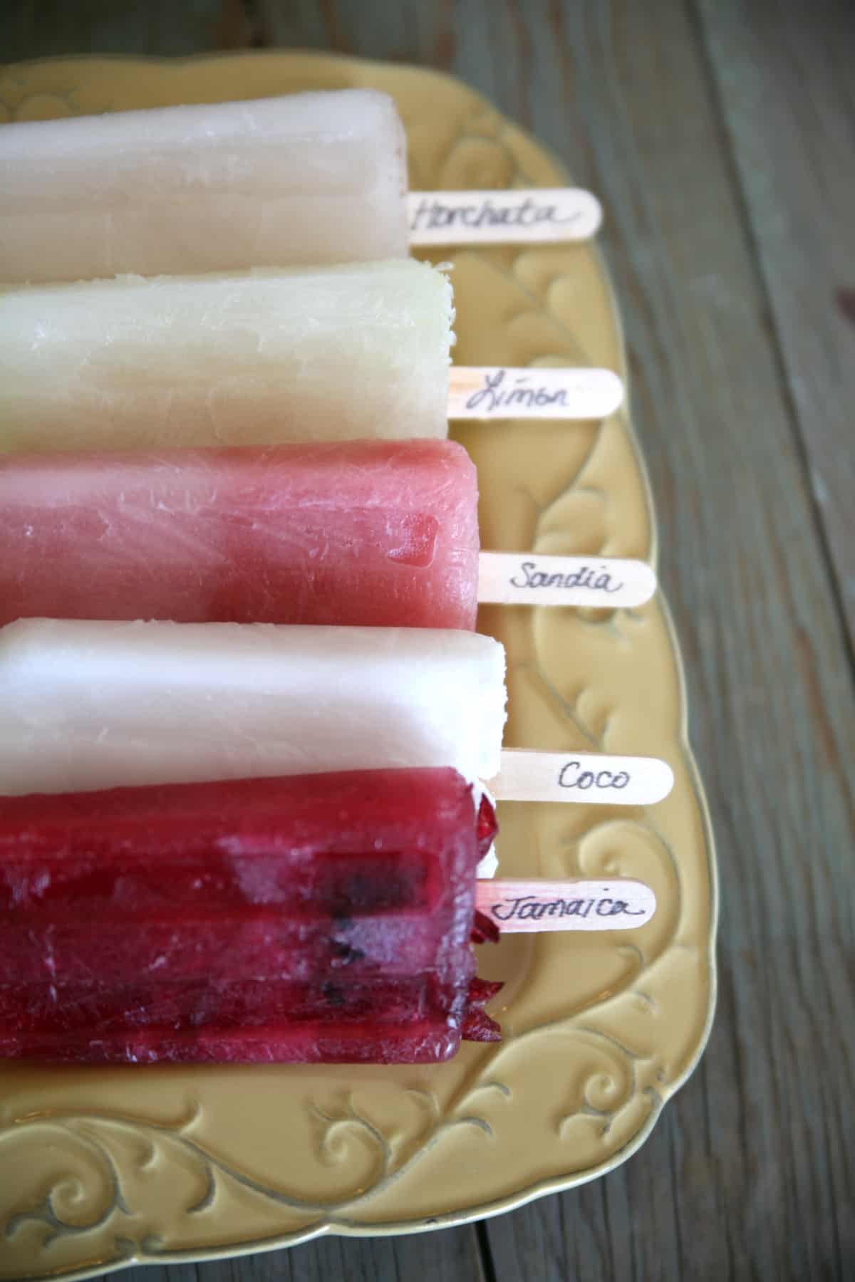 assorted Mexican paletas on a yellow tray