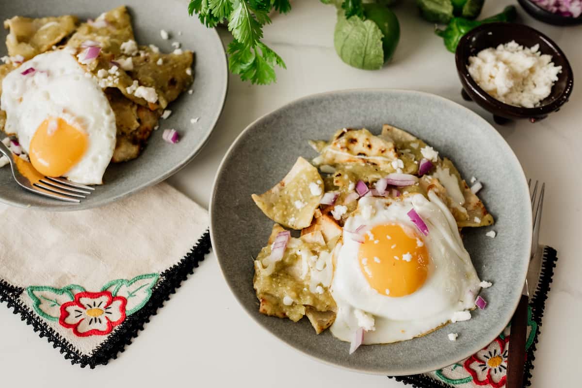 two servings of chilaquiles verdes with fried eggs